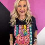 Black tee with neon pink polka dot pumpkin, colorful stripes, stars and florals.