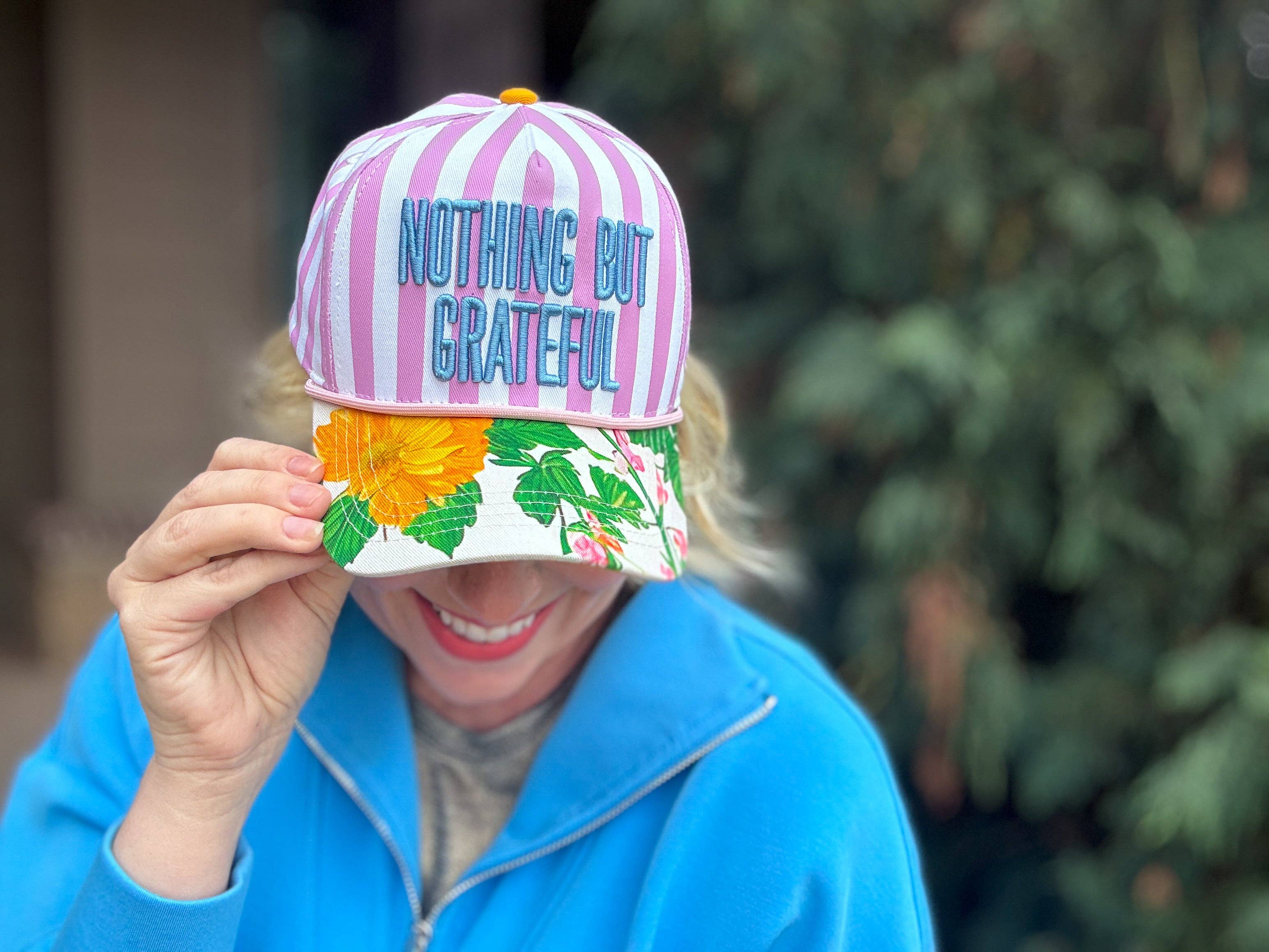 Purple striped baseball hat with floral bill and grateful embroidered message.