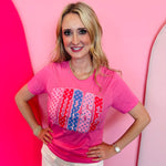 Pink nurse tee with colorful polka dot “NURSE” lettering design