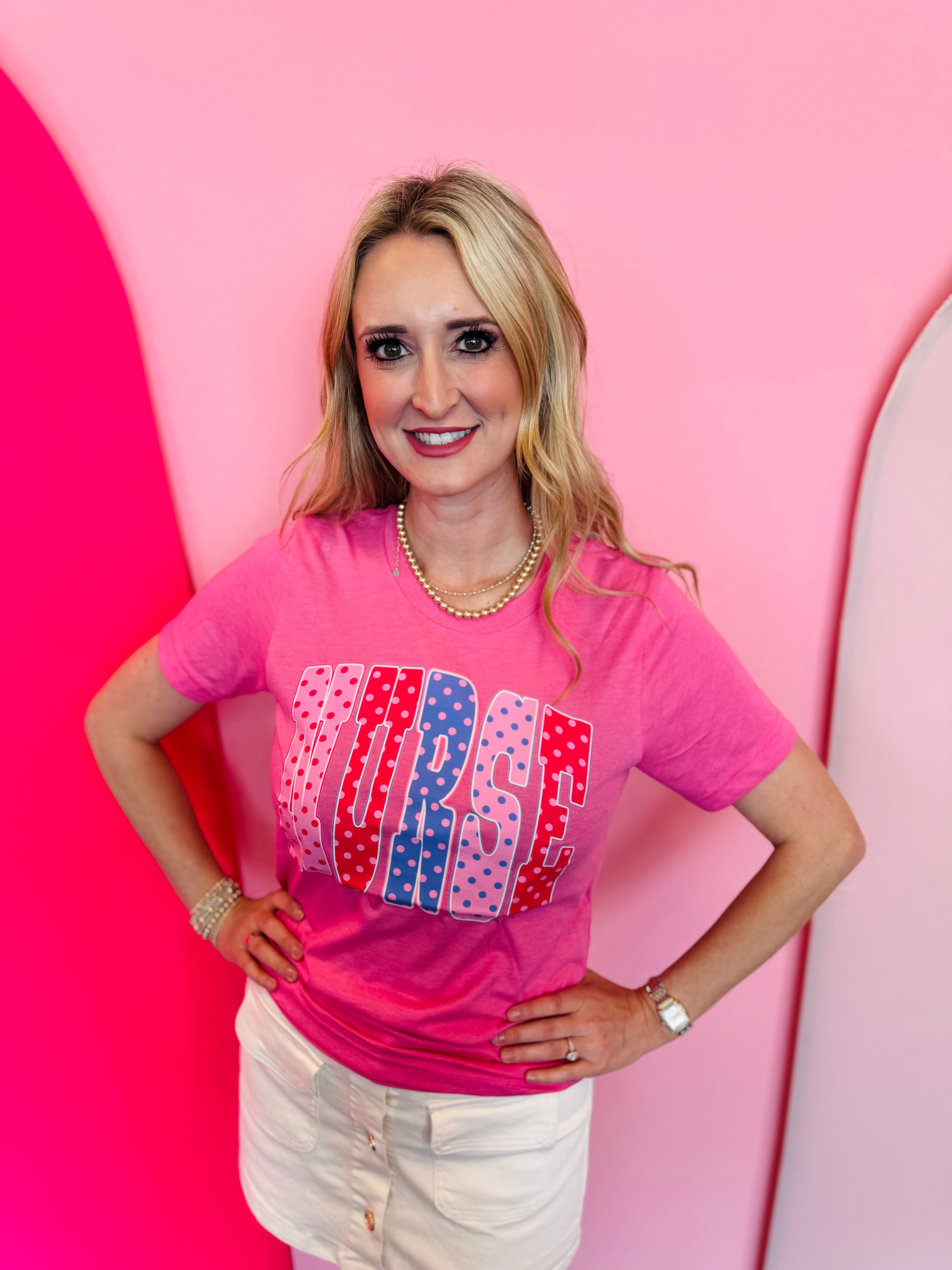 Pink nurse tee with colorful polka dot “NURSE” lettering design