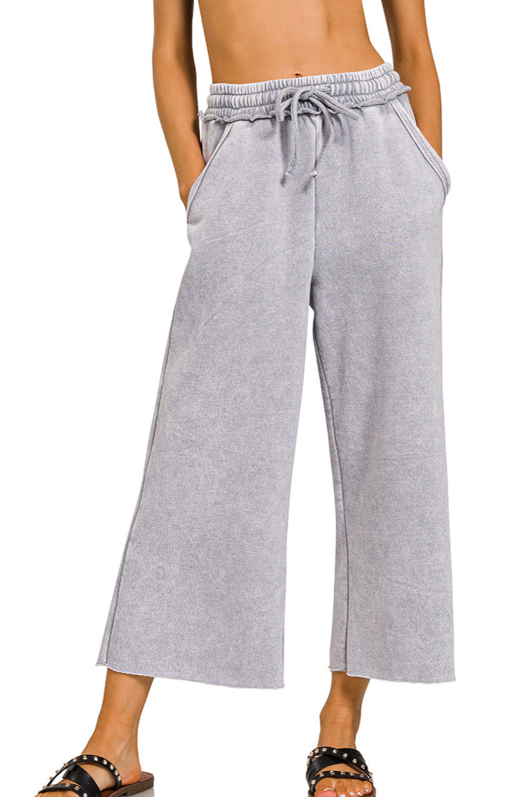 Sleet gray acid wash wide-leg fleece palazzo sweatpants with drawstring waist, raw hem, and pockets.