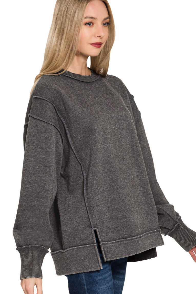 Black acid wash fleece sweatshirt with exposed seam details and side slits
