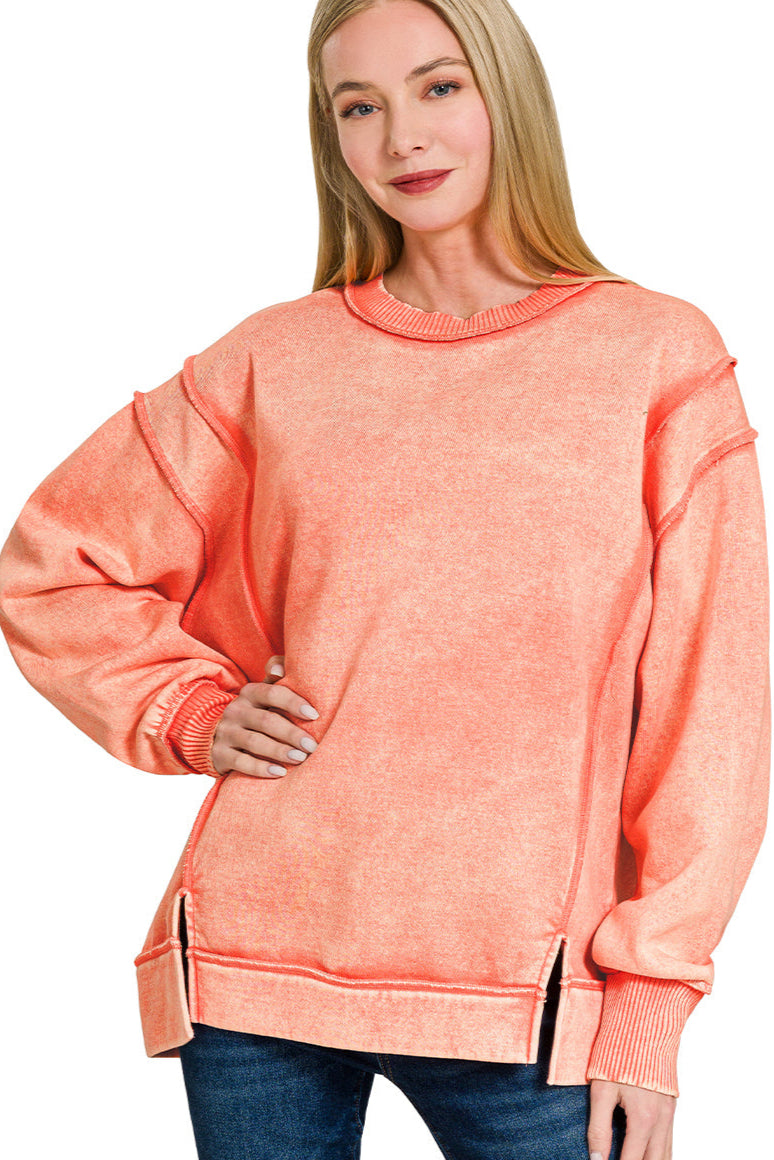 Coral acid wash fleece sweatshirt with exposed seams and side slits.