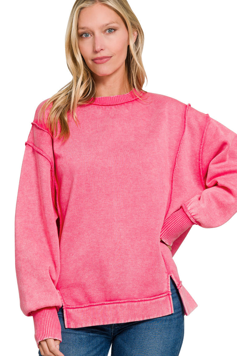 Fuchsia acid wash fleece sweatshirt with exposed seams and side slits.