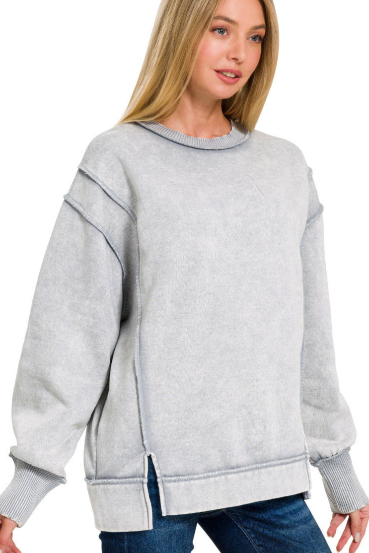 Sleet grey acid wash fleece sweatshirt with exposed seams and side slit.