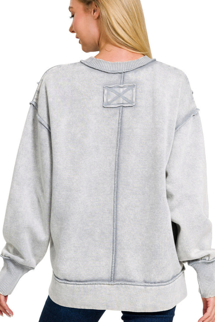 Sleet grey acid wash fleece sweatshirt with exposed seams and side slit.