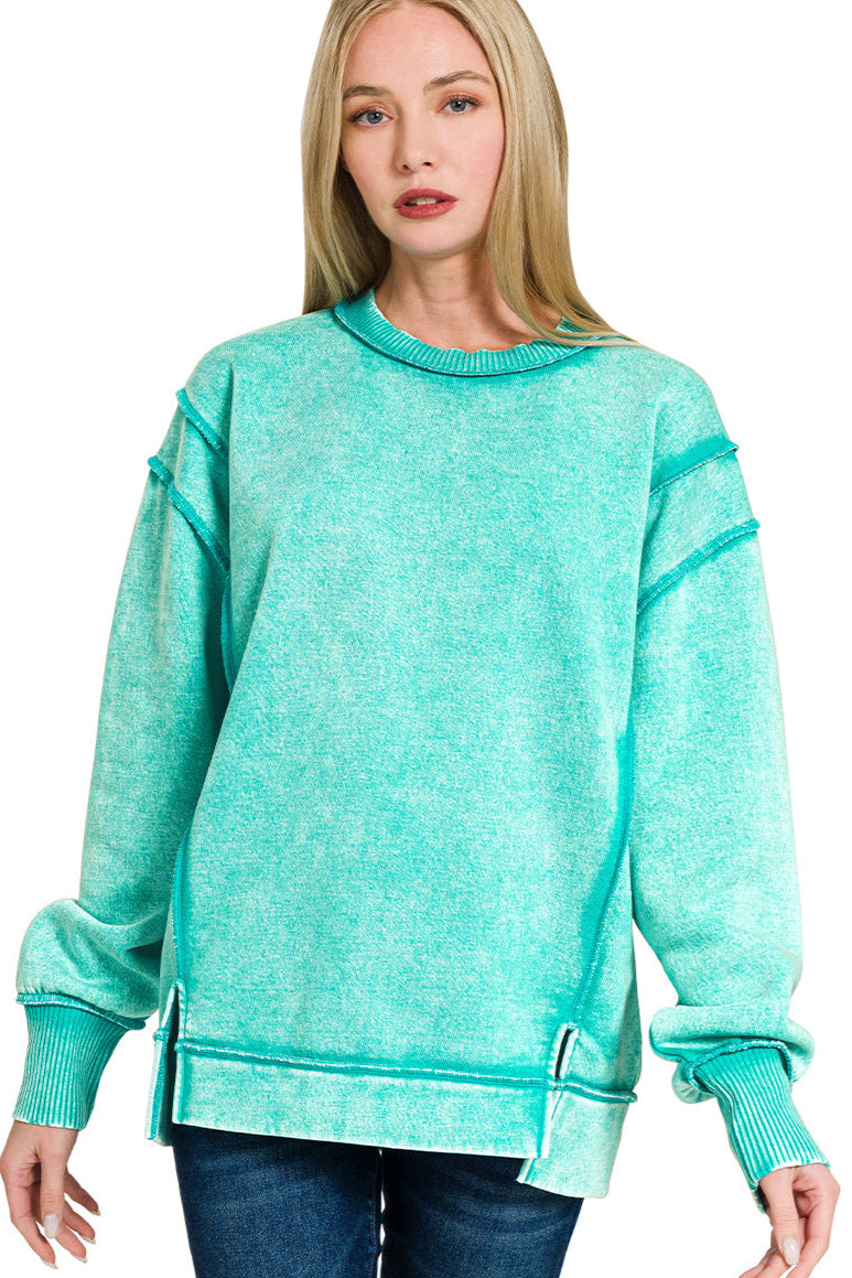 Turquoise acid wash fleece sweatshirt with exposed seams and side slit.