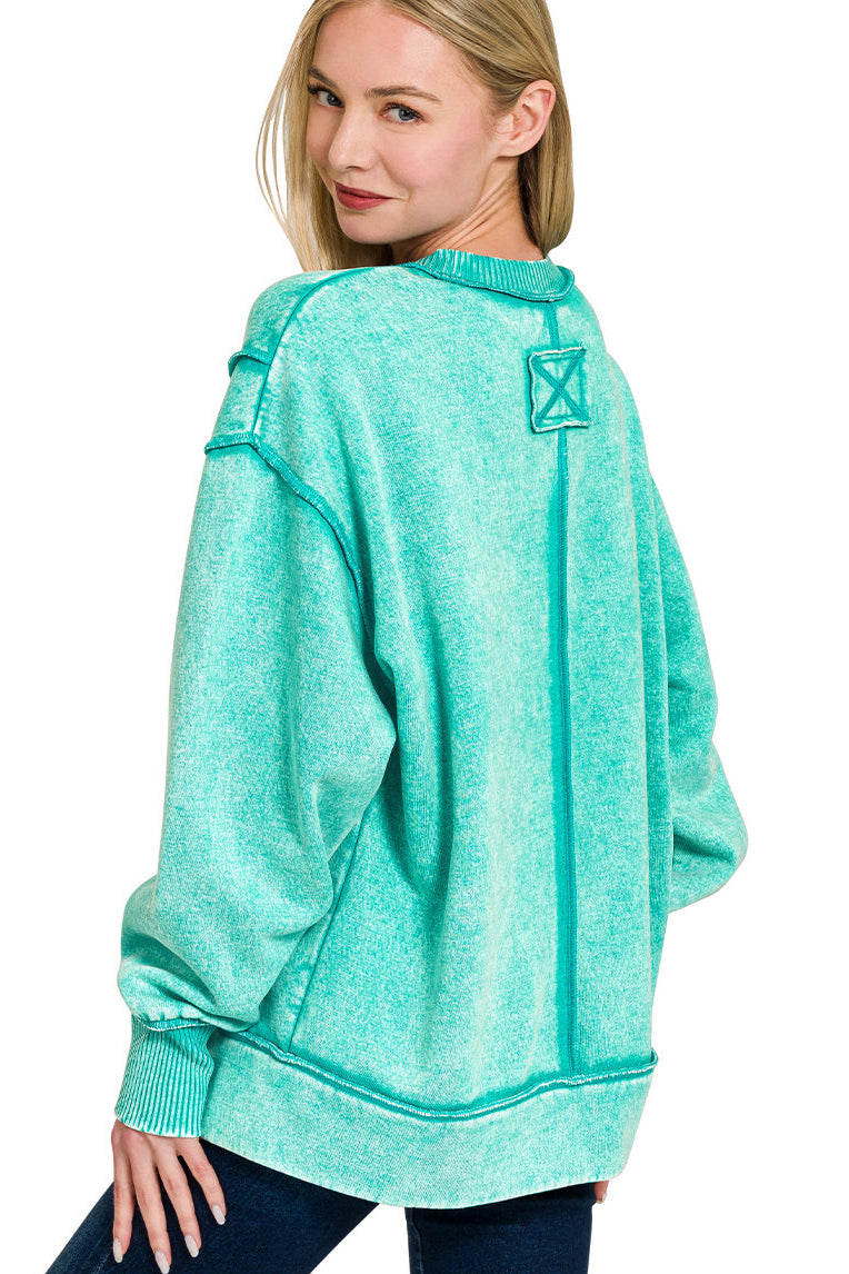 Turquoise acid wash fleece sweatshirt with exposed seams and side slit.
