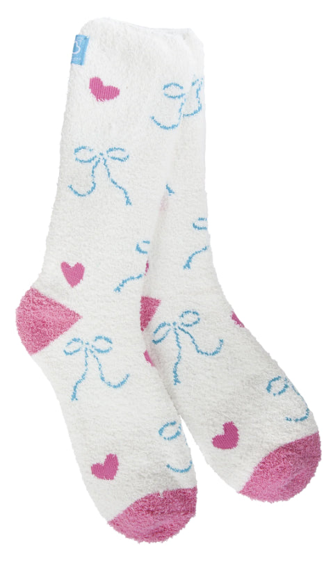 A pair of plush, soft crew socks with a repeating pattern of small blue bows and pink hearts. The socks feature solid, contrasting bright pink heels and toes.