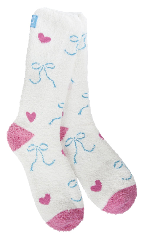 A pair of plush, soft crew socks with a repeating pattern of small blue bows and pink hearts. The socks feature solid, contrasting bright pink heels and toes.