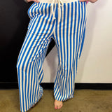 Ocean blue and white vertical striped wide leg pants with drawstring waist and pockets.