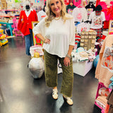 Off white waffle knit top with raw front seam, cuffed 3/4 sleeves, and relaxed boxy fit.