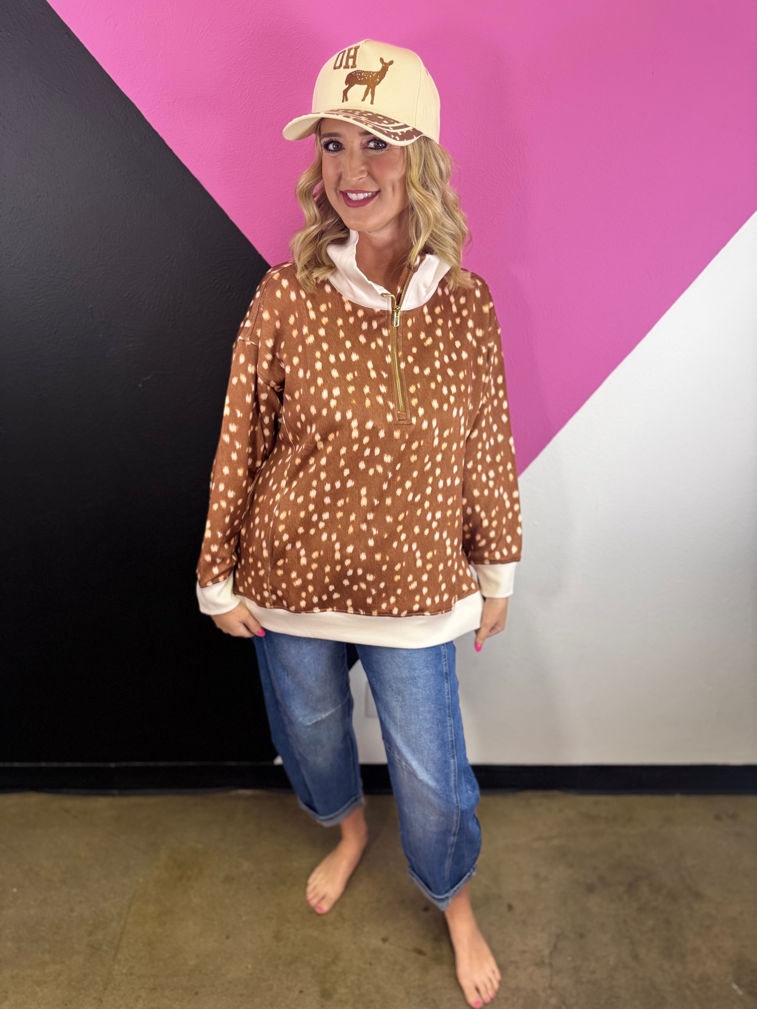 Oh Deer quarter zip pullover with woodland print, contrast trim, and side-slit hem.