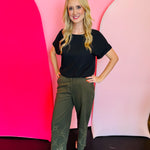 Olive straight-leg cotton pants with eyelet hem detail, elastic back waistband, and side pockets.