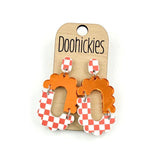 Orange checkered acrylic dangle earrings with hypoallergenic stainless steel settings.