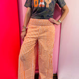 Orange and white gingham wide leg pants with a smocked waistband.