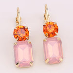 Blush pink rectangular rhinestone dangle earrings on vibrant orange circular rhinestone studs.