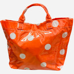 Orange polka dot tote bag with shiny finish and white dots.
