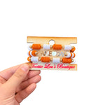 Orange and white Game Day bracelet stack with gold charm accents.