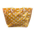 Orange PVC tote bag with white polka dots, dark orange sides, and sturdy top handles.