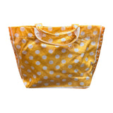 Orange PVC tote bag with white polka dots, dark orange sides, and sturdy top handles.