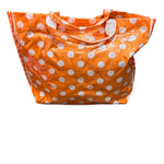 Dark orange PVC tote bag with white polka dots, deeper orange sides, and sturdy handles