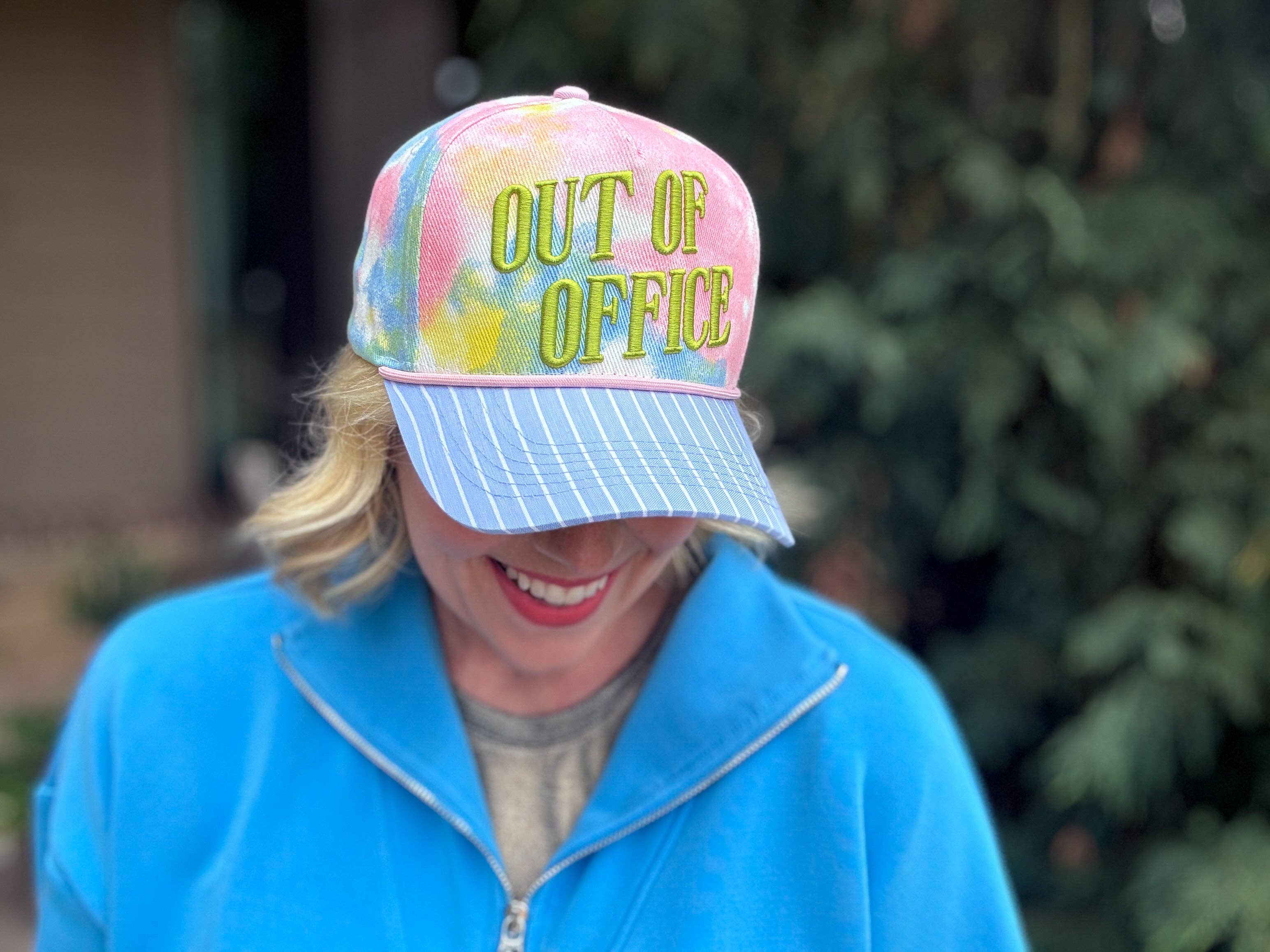 Tie dye baseball hat with blue stripes and Out Of Office embroidery.
