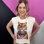 Cream sleeveless tiger muscle tee with layered sparkling jeweled necklace details.
