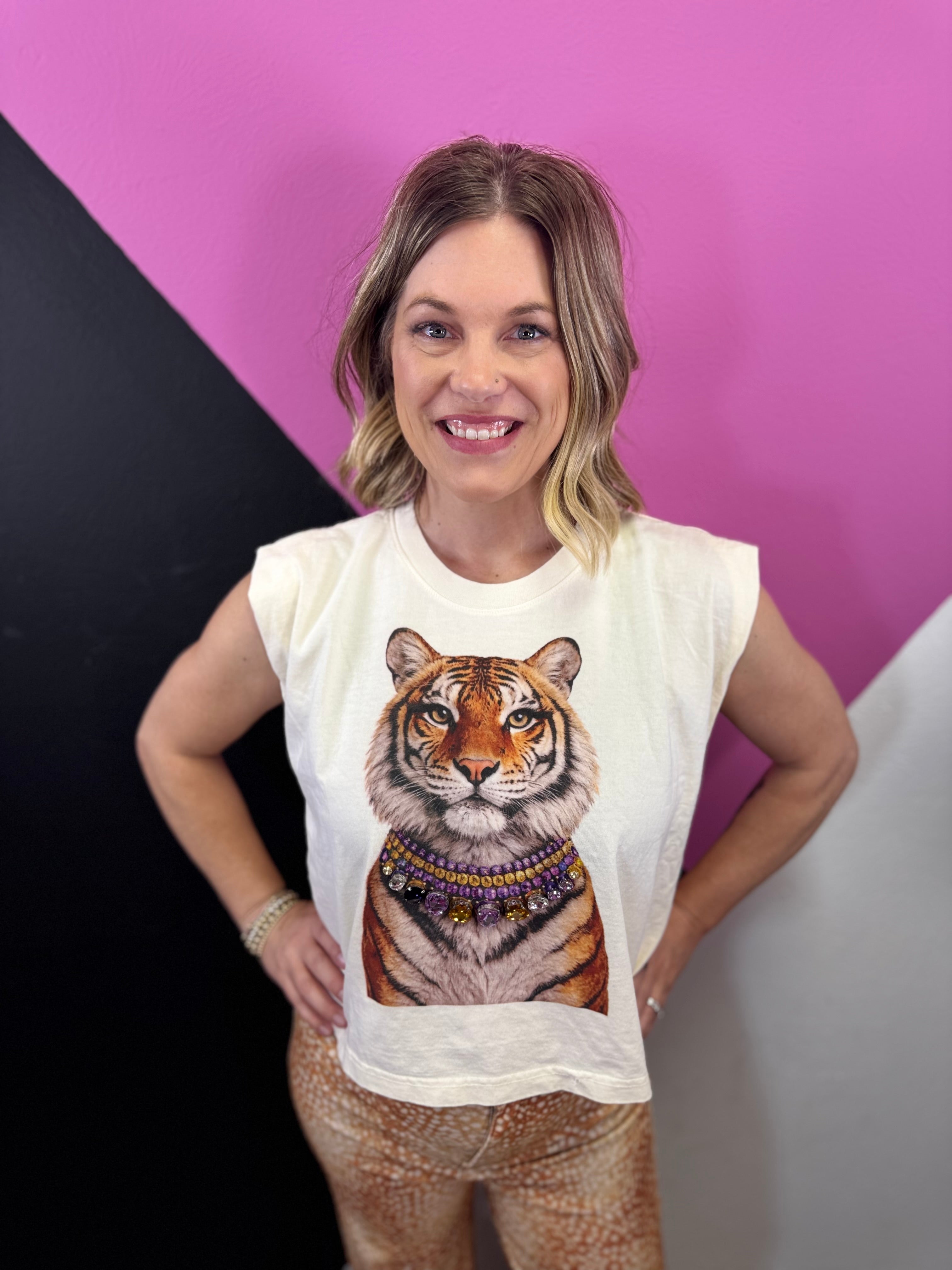 Cream sleeveless tiger muscle tee with layered sparkling jeweled necklace details.