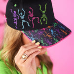 Black Halloween hat with colorful purple, pink, blue, green, and orange embroidered skeletons.