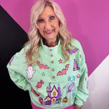 Mint Halloween pullover with colorful pumpkins, bats, candy, witch hats, sequins, and gemstone buttons.
