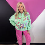 Mint Halloween pullover with colorful pumpkins, bats, candy, witch hats, sequins, and gemstone buttons.
