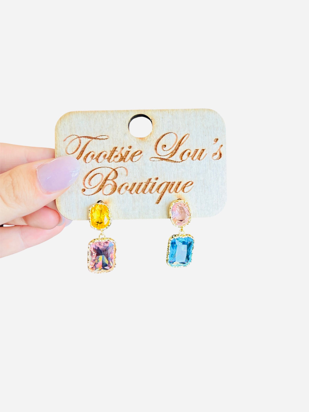 Pastel rhinestone dangle earrings with pink, yellow, and blue stones framed in gold trim.