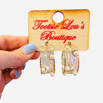 Clear acrylic hoop earrings with pearl bead accents and thin gold wire trim.