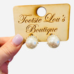 Faux pearl stud earrings topped with sparkling rhinestone crown accents for an elegant, classic look.