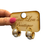 Wide gold hoop earrings with raised square pearl accents for a chic, elegant look.