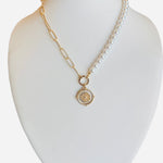 Half pearl, half gold chain necklace with gold pendant and sparkling crystal detail.