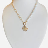 Half pearl, half gold chain necklace with gold pendant and sparkling crystal detail.
