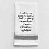 White tea towel with black trim and funny aging quote.