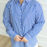 Royal blue and white wrinkle-free striped oversized button-down shirt.