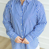 Royal blue and white wrinkle-free striped oversized button-down shirt.