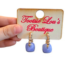 Gold beaded hoop earrings with glossy periwinkle blue resin cube accents.
