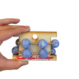 Periwinkle marbled bubble bracelet stack with oversized beads and gold spacers.