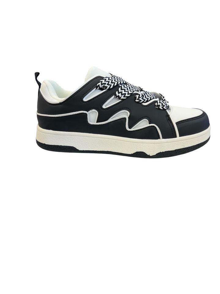 Black and white sneakers with a bold wave design, thick platform sole, and zigzag laces — modern, sporty, and edgy.