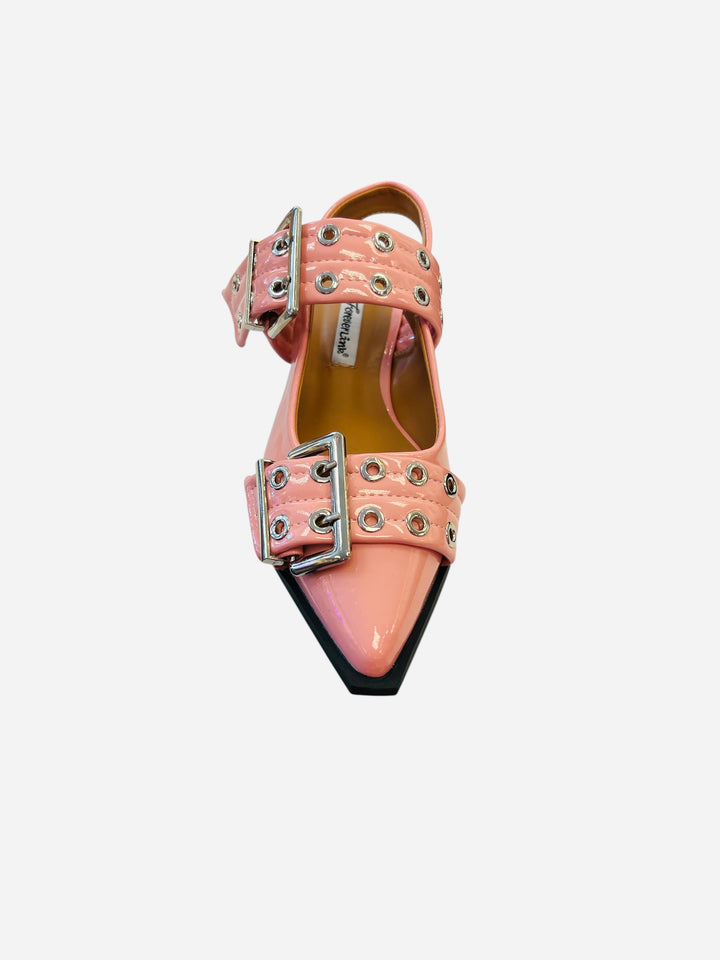 Pink pointed-toe flats with bold silver double buckle straps and a slingback backstrap, combining vibrant color with edgy charm.