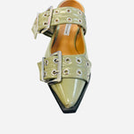 Olive pointed-toe flats with bold silver double buckle straps and a slingback backstrap, combining vibrant color with edgy charm.