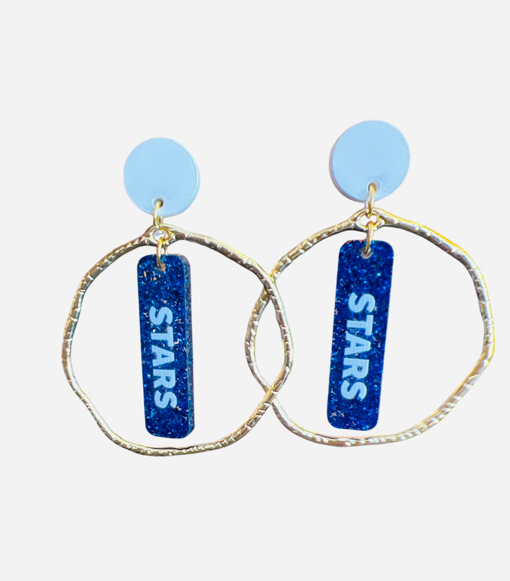 Glittery blue dangle earrings with white STARS lettering, white stud, and gold circle frame—perfect for bold game day spirit.