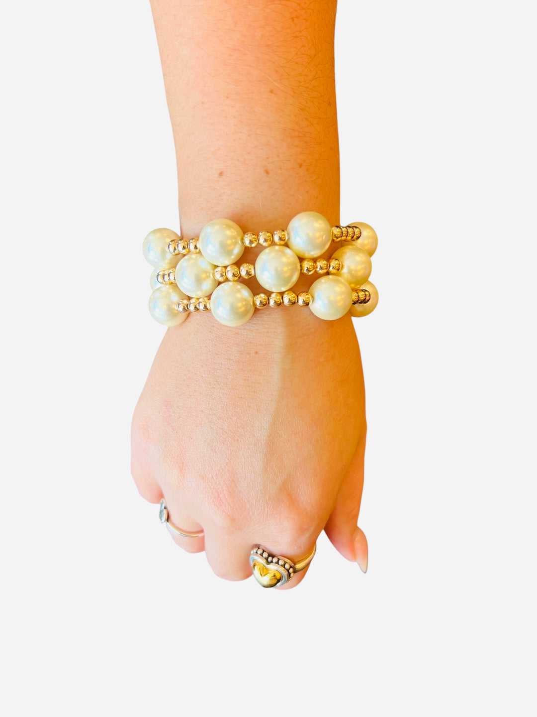 Set of 3 water-resistant pearl and gold beaded stretch bracelets with 14mm pearls and 5mm gold beads.
