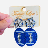 A pair of dangle earrings, each with a sparkling crystal star stud at the top. Dangling below is a football-shaped charm made from vibrant blue beads.