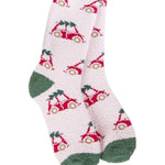 A pair of plush, soft crew socks featuring a repeating pattern of a vintage red bug car with a Christmas tree on its roof. The socks have solid green heels and toes.